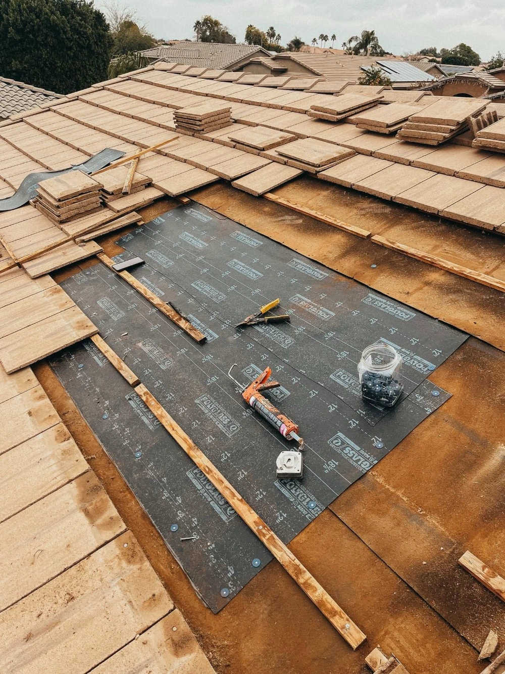 Roof decking with underlayment and tools during a repair