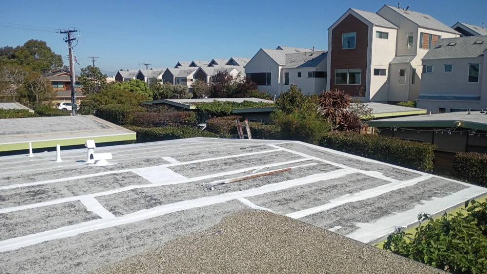 White commercial flat roof membrane with parking-lot-style line markings